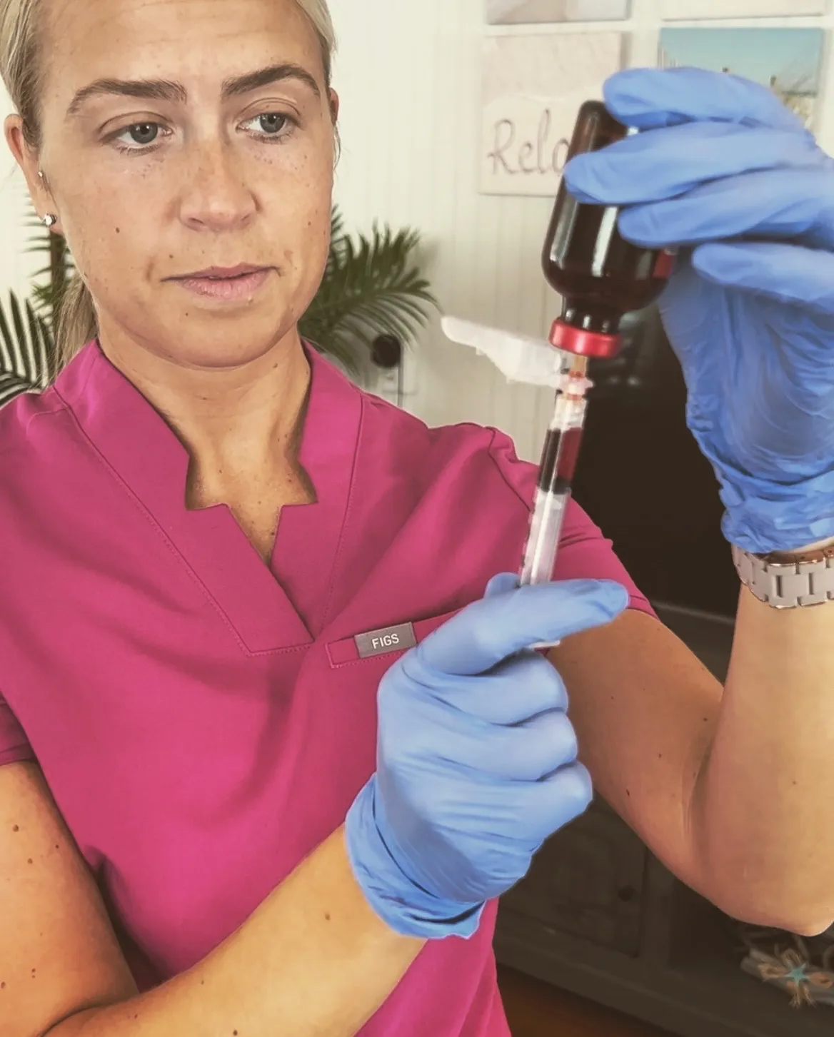 A nurse practitioner from our team drawing up a vitamin syringe before a home visit